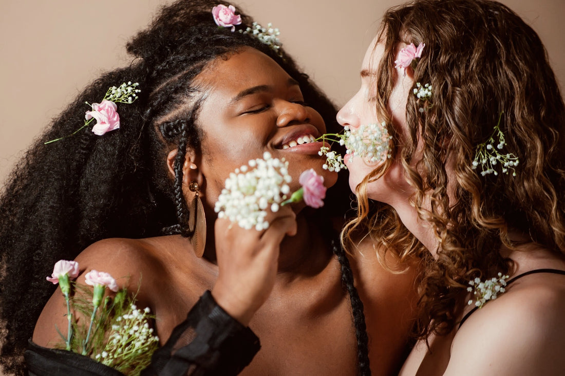 Queer, Trans, and In love - Two Models Mailing at Each Other Lovingly and Holding Flowers