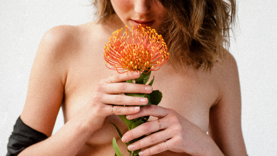 Endocrine Disrupting Chemicals - Topless Model Holding Orange Flower