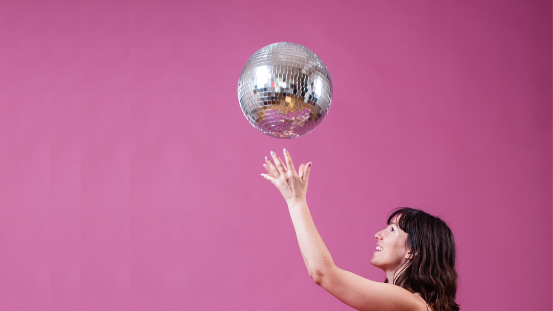 5 Simple Daily Habits to Help You Keep Your Resolutions - Model Playing with a Disco Ball On a Pink Background