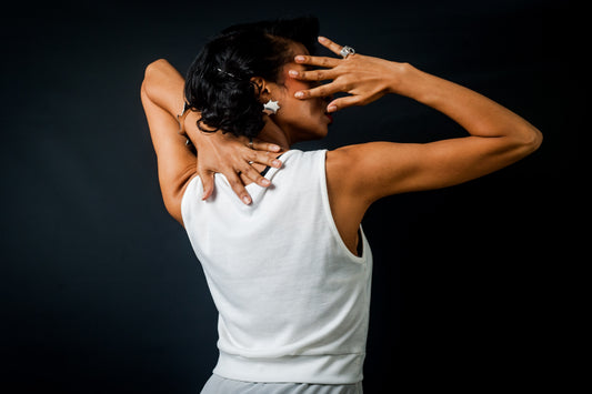 Updates for Our Community During a Global Crisis - Back of Model in White Tank Top with Hands Covering Face