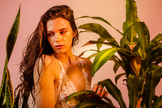 Welcome to Momotaro Apotheca - Model in White Bra Surrounded by Plants