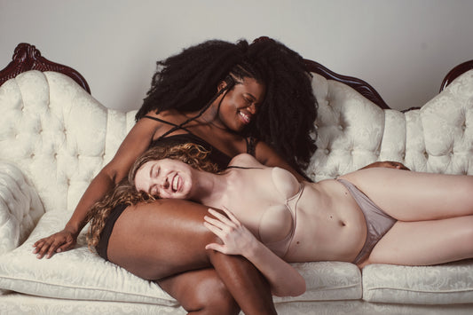 Human Rights & the 2018 Midterm Elections - Two Models Laying on a Couch and Laughing