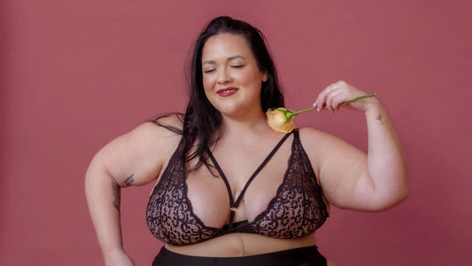 queer woman smilies cutely holding a rose - LGBTQ Tips for allies
