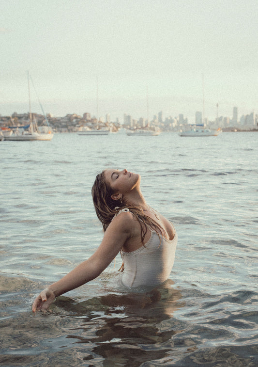 Certified Life & Period Coach - Model in White Tank Top Standing in the Ocean