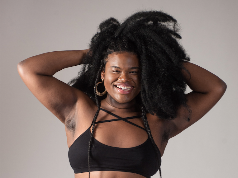 Celebrating Black History Month - Model in Black Bra Smiling with hands in her Hair