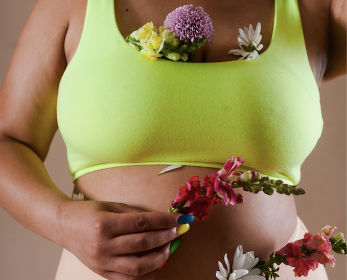Non-Essential Essentials for Self-Care - Torso of Model in Green Bra Covered in Flowers