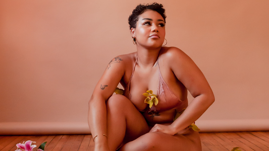 Putting an End to STI Stigma - Model in Silk Lingerie Sitting on the Flow Covered in Flowers
