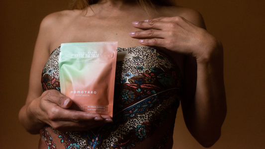 5 Facts About UTIs - Closeup of model in bandeau top holding a UTI Supplements 