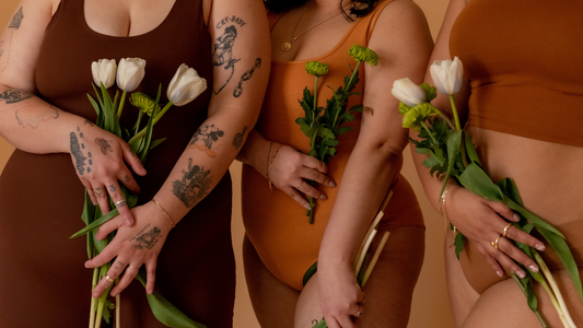 Pelvic Health Priorities - Closeup of three models in neutral clothes holding white roses