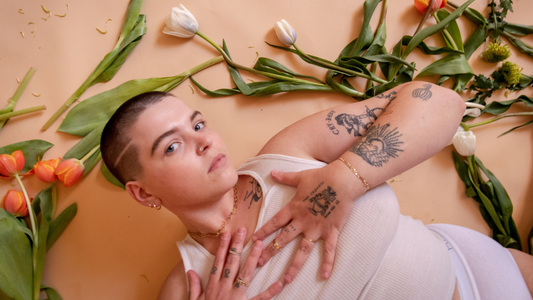 Are You There, God? It's Molly-Margaret - Closeup of model in white tank top surrounded by flowers