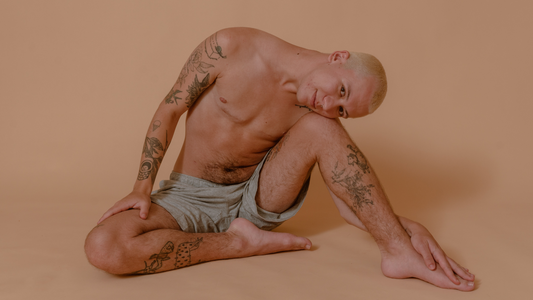 Clark wearing light blue shorts on beige background