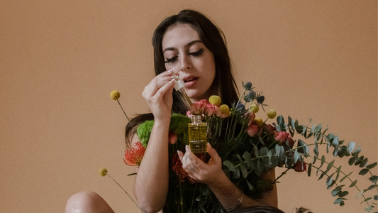 7 Home Remedies for Yeast Infections - Model covered by flowers and holding a Tonic