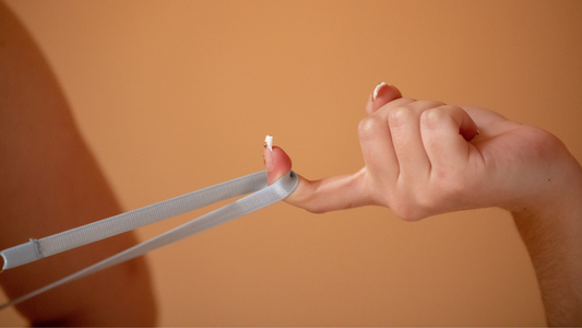 4 Questions to Ask Yourself Before Deciding to Have Sex - Closeup of and pulling on blue bra strap