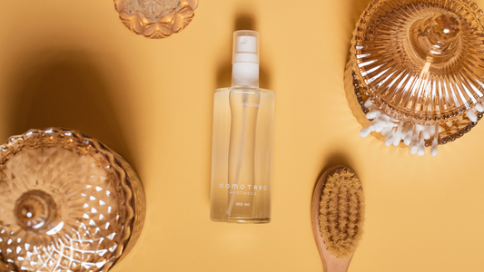 6 Ways to Use the Hydrosol - Hydrosol on yellow background surrounded by a hair brush and bronze glasses