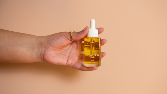 Tonic Oil Uses - closeup of hand holding a bottle of Tonic