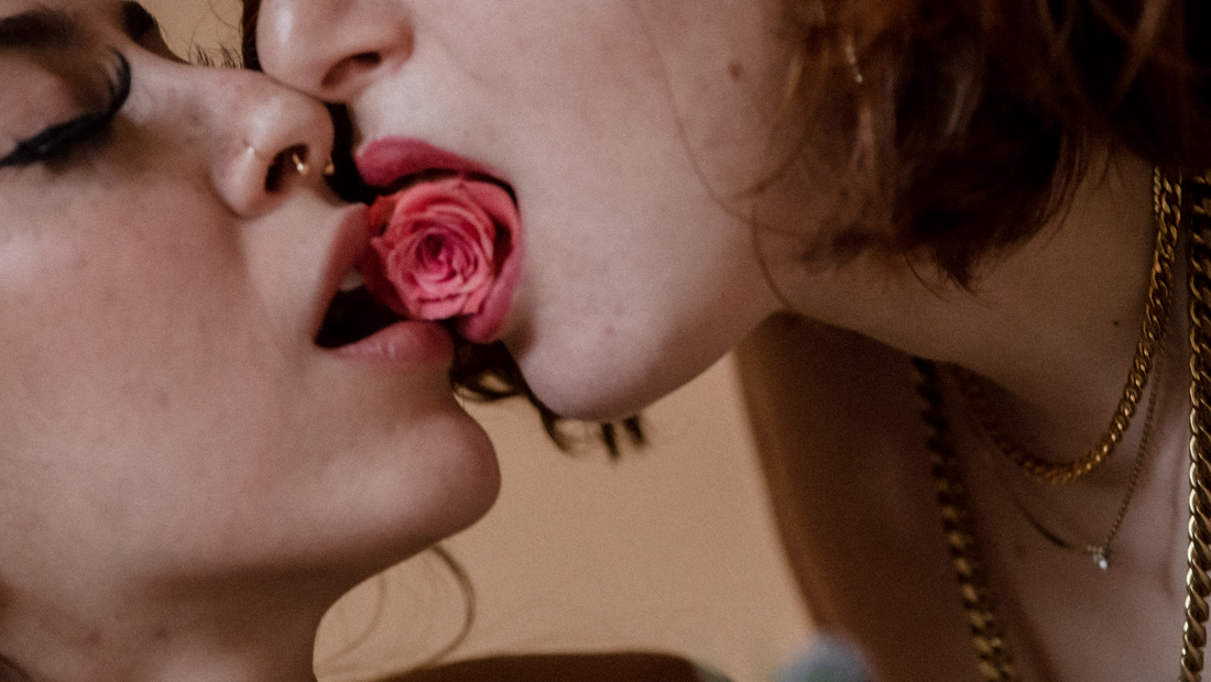 Curative Kink: How to Heal From Trauma & Build Boundaries in the Bedroom - Two Models Pressing their Lips Together with a Rose in the Middle 