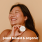 Woman smiling and holding our plant based and organic salve.